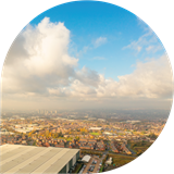 Aerial image of an industrial building and Greater Manchester skyline